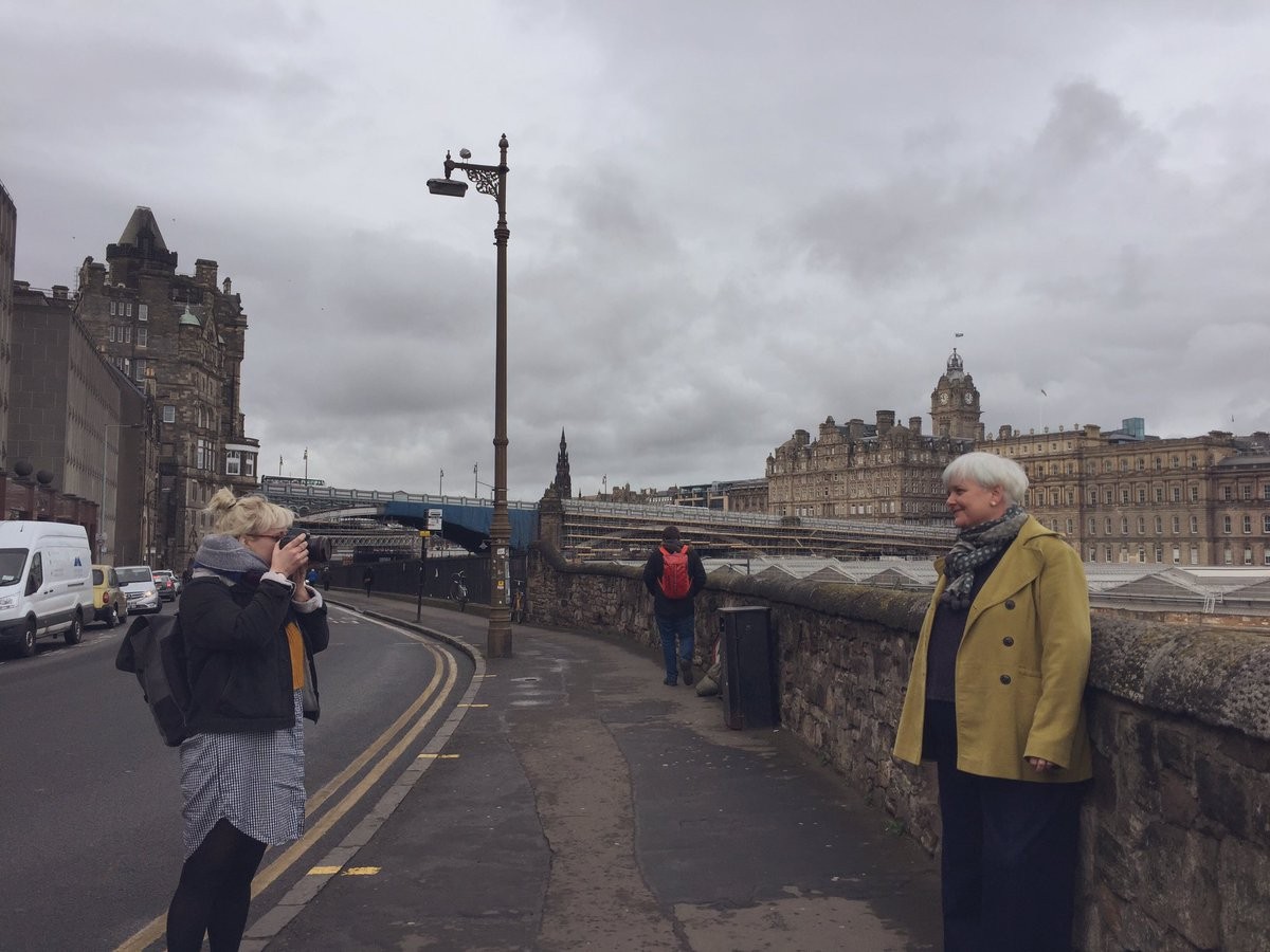 Dr Angela O'Hagan being photographed in front of St Andrew's House