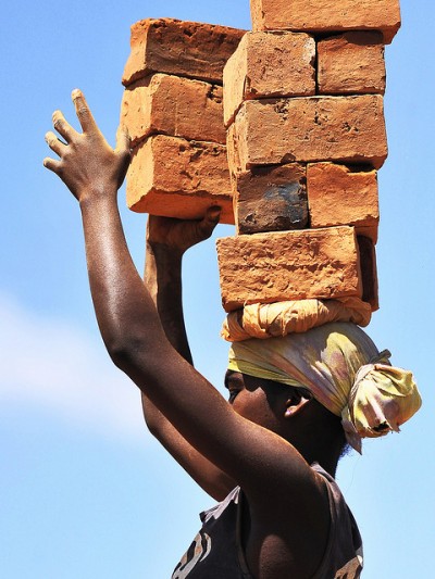 Woman carrying bricks