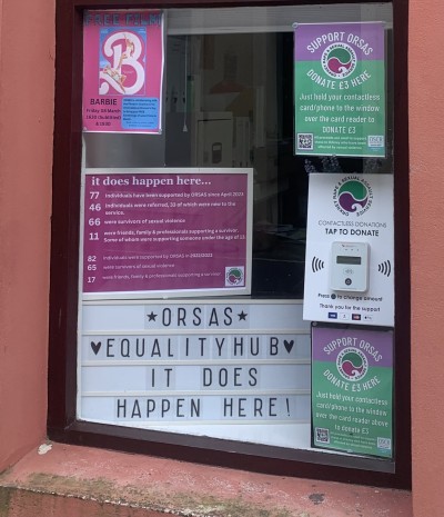 A photo of the ORSAS equality hub showing flyers in the window.